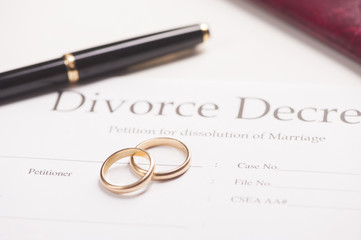 divorce decree with rings and pen