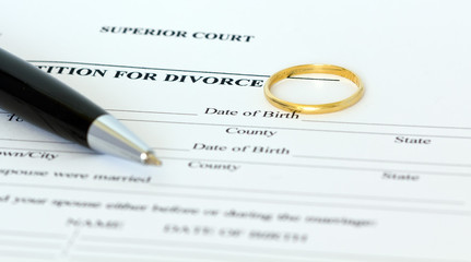 divorce papers with ring and pen